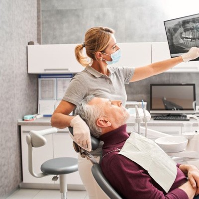 Dentist and patient reviewing X-ray together