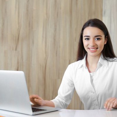 Friendly receptionist at dental office front desk