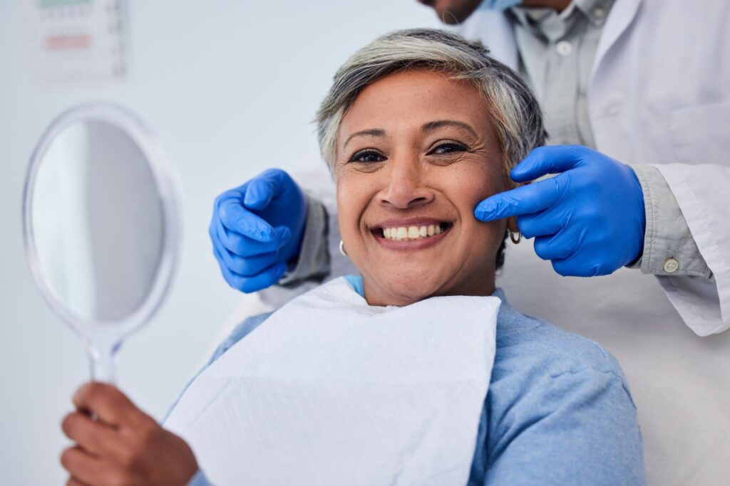 An older woman getting a cosmetic dentistry procedure.