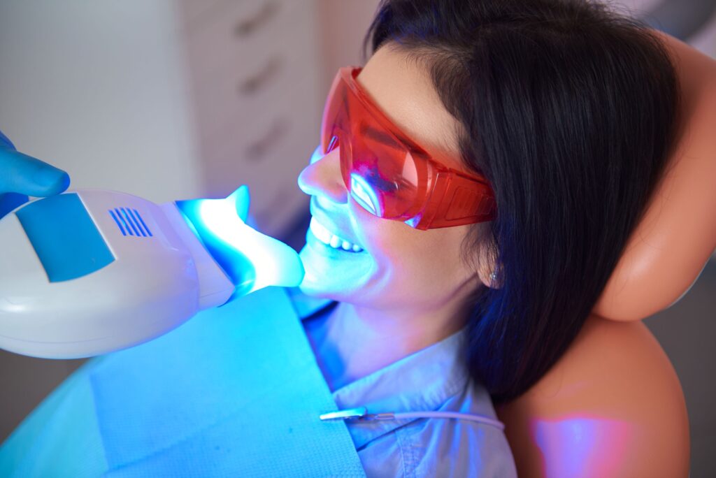 Woman having teeth whitened at the dental office